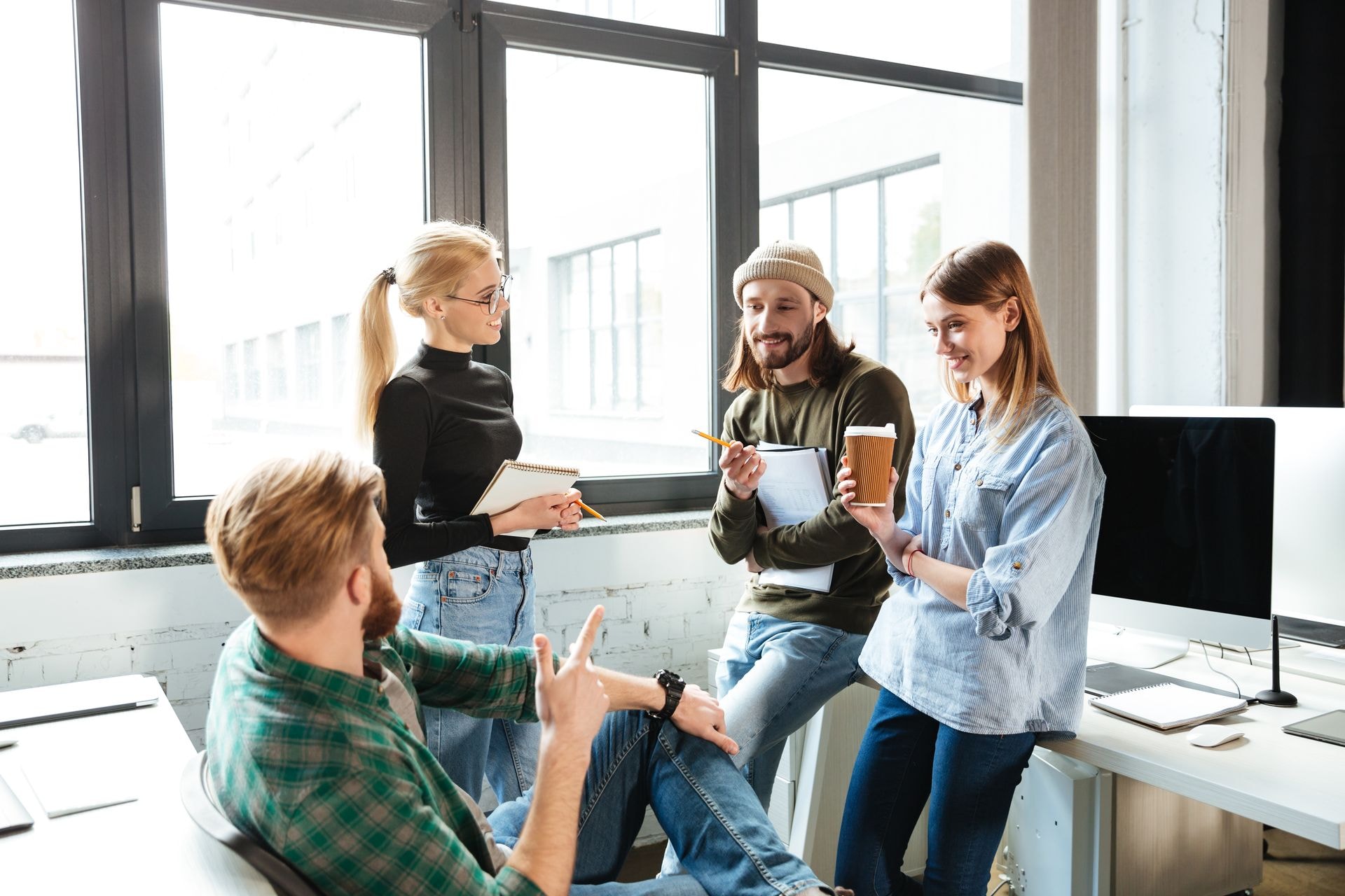 colleagues-standing-office-talking-with-each-other